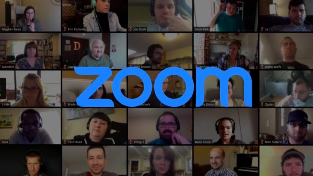 A screenshot of a Zoom call with the Zoom logo imposed over it.