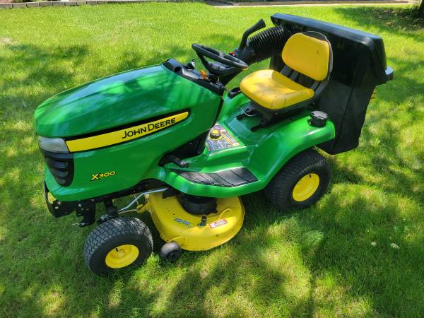Photo John Deere x300 Tractor with twin Bagger $1,900