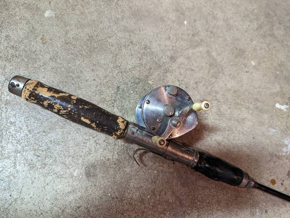 Old steel fishing pole and casting reel $15