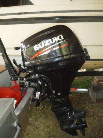 Photo 15 hp Suzuki outboard motor with fuel tank $2,590