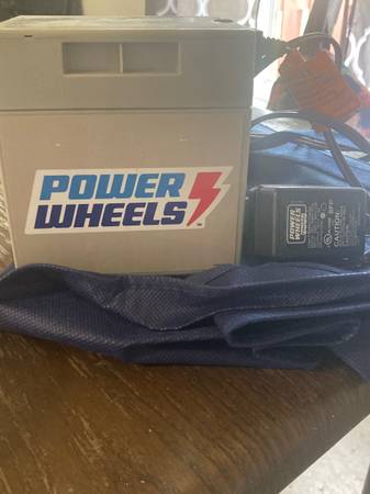Photo 12v power wheels battery and charger cord $40