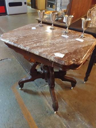 Photo Biscuit top brown marble parlor table, center post, aprons, casters $365