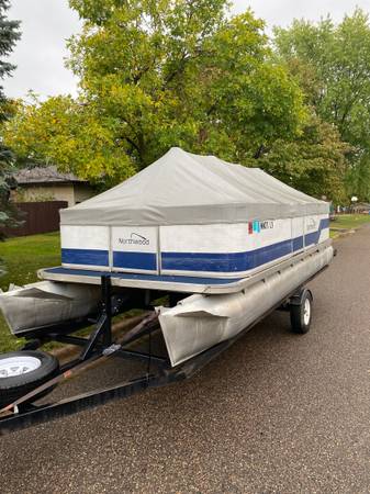 Photo 21 pontoon with 50 Hp 4 stroke Honda and Bunk trailer $7,990