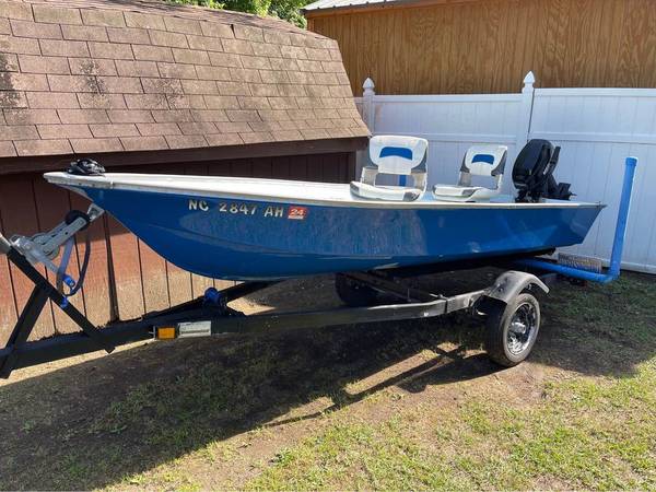 Photo Boat, trailer, and outboard motor $2,500