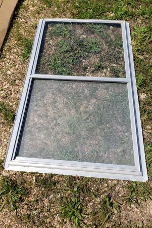 Photo Aluminum Storm Window in size 30 12W x 51 12H with side adjusters $25