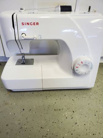 Photo Singer sewing machine and table $100
